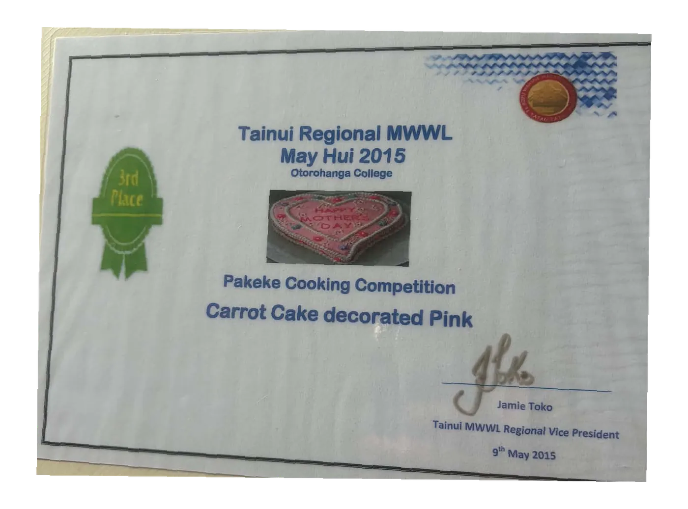 Certificate: Tainui Regional MWWL, May Hui 2015, Pakeke Cooking Competition, carrot cake decorated pink, with a photo of the cake and a 3rd place ribbon.